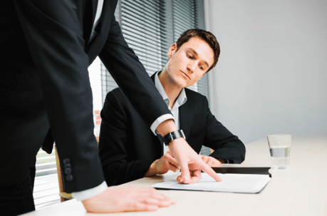 An employee receiving a Performance Improvement Plan (PIP) from a boss