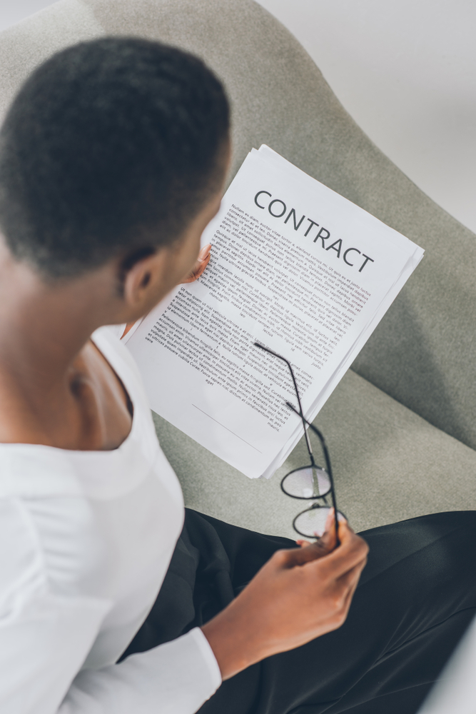 Woman reading contract and considering a tort claim attorney